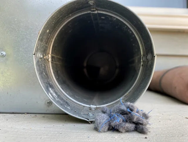 Newington Dryer Vent Cleaning technician using specialized equipment to clear severe dryer vent blockage in Newington